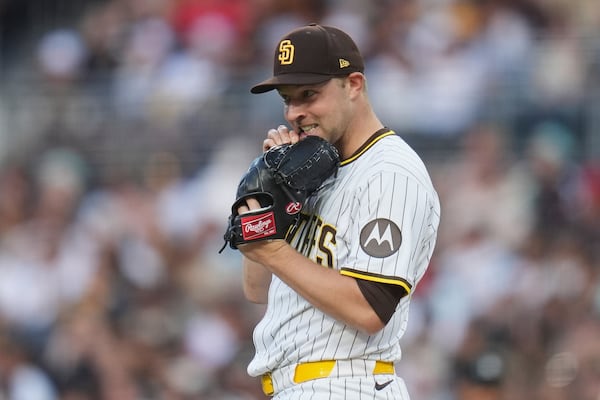 San Diego Padres starting pitcher Michael King tightens his glove with his teeth as he works against a Los Angeles Angels batter during the second inning of a baseball game Monday, May 12, 2025, in San Diego. (AP Photo/Gregory Bull)