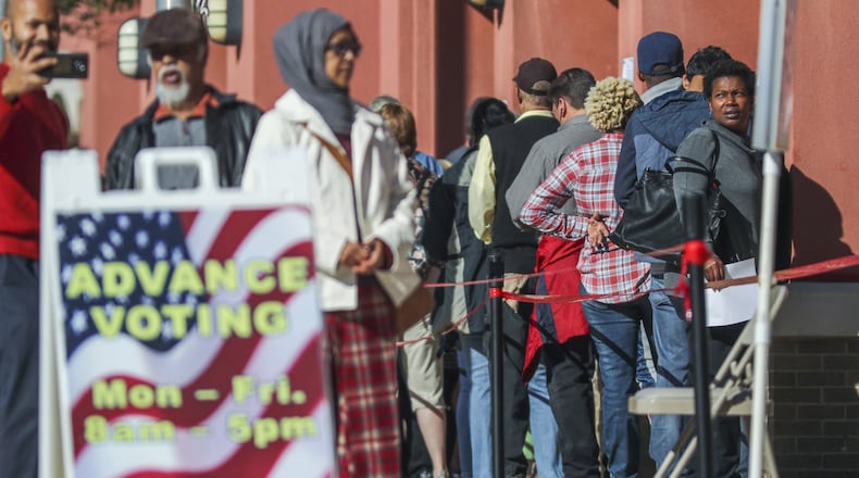 Fahim Akbar (far left) makes a selfie with his parents, Jalal Akbar and Ruby Begum after they voted on Thursday Oct. 18, 2018 at the Cobb County West Park Government Center at 736 Whitlock Ave NW in Marietta that had long lines and waits all week long for early voting that sometimes stretched to three hour waits. JOHN SPINK/JSPINK@AJC.COM