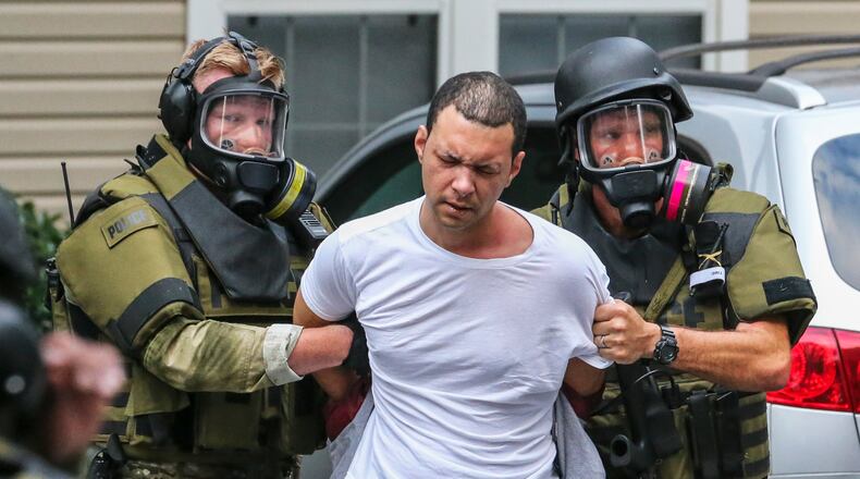 Hours after a man with an extensive criminal history barricaded himself inside a Smyrna apartment complex and prompted a standoff early Friday, July 1, 2016 police took the man into custody. About 3 a.m., officers received a phone call about a domestic dispute at the Brighton Way Apartment Homes on Parkway Avenue, Smyrna police spokesman Louis Defense said. Police were familiar with the address. Officers have gone there "on numerous occasions," Defense said. When they got to the scene Friday, they found a woman with multiple injuries and tried to make contact with a man in the apartment, Defense said. "He told them to go away and barricaded himself inside of the apartment," Defense said. "Our hostage negotiators arrived on the scene." They tried to negotiate with him for several hours to no avail. "We introduced a tactical element and he came out peacefully," Defense said. The man, whose name was not released, was taken to the Smyrna City Jail on unspecified charges. The woman's condition was not known. JOHN SPINK /JSPINK@AJC.COM