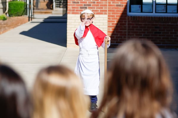 Pope David, a.k.a. second grader David Levergood, offers a blessing as he appears after being elected the new pope during a mock papal conclave at Pinecrest Academy on May 6, 2025. (Miguel Martinez/AJC)