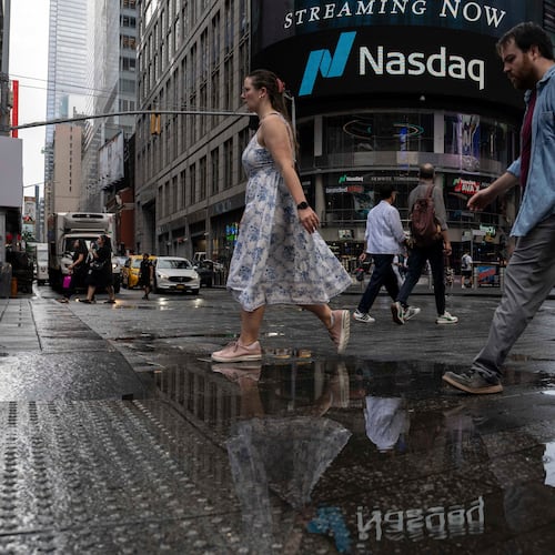 People walk past the Nasdaq MarketSite, Thursday, Aug. 6, 2026, in New York. (AP Photo/Yuki Iwamura)