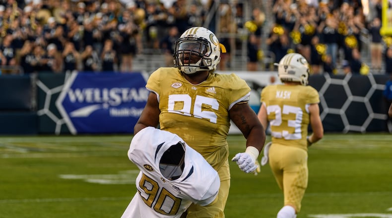 At Georgia Tech's spring game April 26, defensive tackle Chris Martin carried the jersey and shoulder pads of the late Brandon Adams onto the field at Bobby Dodd Stadium. (Danny Karnik/Georgia Tech Athletics)