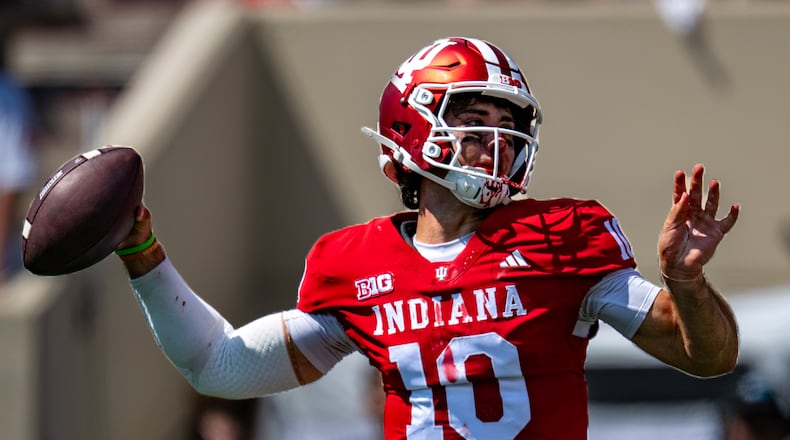 A bloodied Indiana quarterback Josh Hoover (10) looks to pass during the first half of an NCAA college football game against North Texas, Saturday, Sept. 5, 2026, in Bloomington, Ind. (AP Photo/Doug McSchooler)