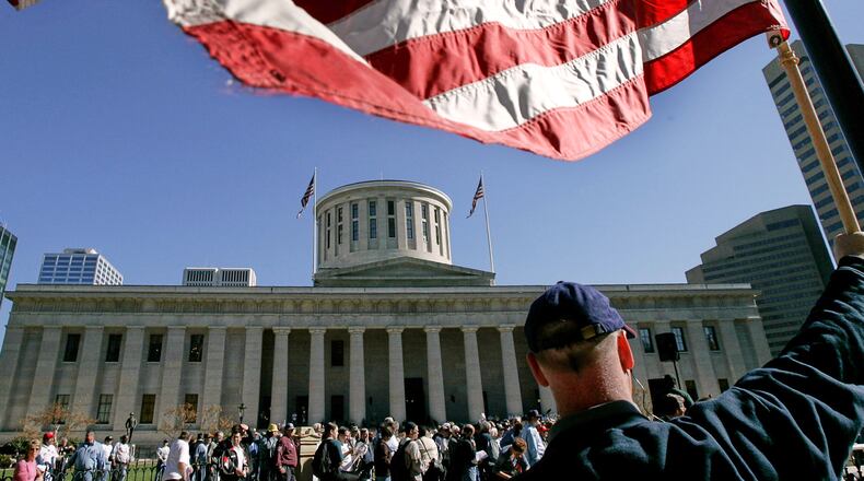 An American flag is outside the state capitol building in Columbus, Ohio, Oct. 25, 2004. (AP Photo/Laura Rauch, File)