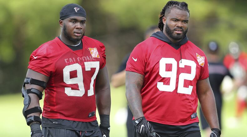 Atlanta Falcons defensive tackles Dontari Poe (92) and Grady Jarrett walk off the field after NFL football practice Tuesday, June 13, 2017, in Flowery Branch, Ga. (Curtis Compton/Atlanta Journal-Constitution via AP)