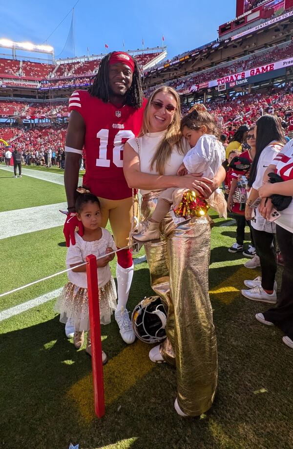 Former Georgia wide receiver Chris Conley stands with his wife, Brianna, and daughters Calani (standing) and Caia before a San Francisco 49ers game at Levi's Stadium in Santa Clara, Calif. Conley played for the 49ers in the 2023 and 2024 seasons before retiring. (Courtesy of Chris Conley)