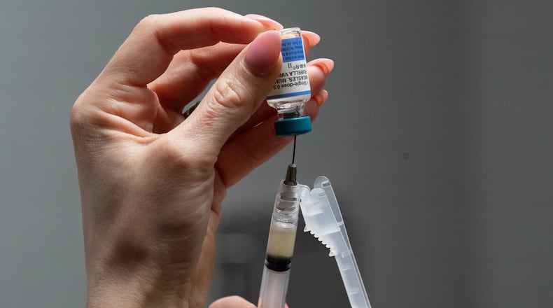 FILE - Lauren Ellenburg, a nurse, prepares a combination measles, mumps and rubella vaccine for a patient at Tiger Pediatrics in Easley, S.C., March 17, 2026. (AP Photo/Mary Conlon, File)
