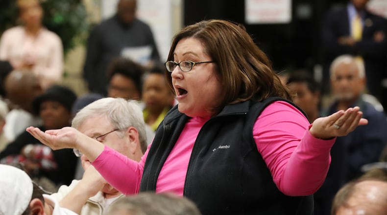 Jennifer Tate, who says trying to get her water bill fixed has become a part-time job, speaks out in frustration during a town hall meeting at the Maloof Auditorium on Nov. 10, 2016, in Decatur.    Curtis Compton/ccompton@ajc.com