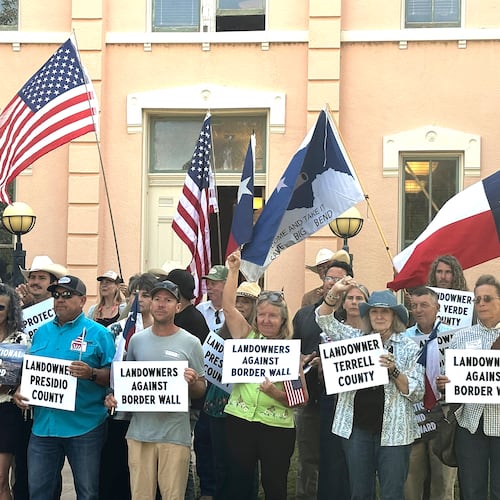Landowners and other supporters hold signs against the Trump administration's plans to build a border wall and other infrastructure in Texas' remote Big Bend region, Monday, Sept. 14, 2026, in Marfa, Texas. (AP Photo/Rebecca Santana)