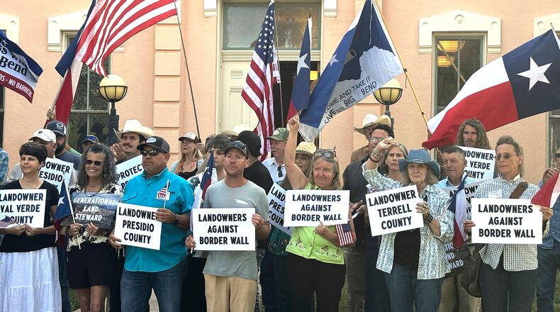 Landowners and other supporters hold signs against the Trump administration's plans to build a border wall and other infrastructure in Texas' remote Big Bend region, Monday, Sept. 14, 2026, in Marfa, Texas. (AP Photo/Rebecca Santana)