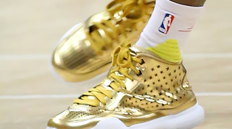 Hawks guard Dennis Schroder wears gold shoes during a game at the 76ers on Wednesday, Dec. 16, 2015, in Atlanta. Curtis Compton / ccompton@ajc.com