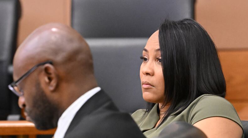 District Attorney Fani Willis sits with special prosecutor Nathan Wade during a motion hearing in July. Legal experts are split as to whether allegations against Willis and Wade could disqualify her office from prosecuting former President Donald Trump. (Hyosub Shin / Hyosub.Shin@ajc.com)
