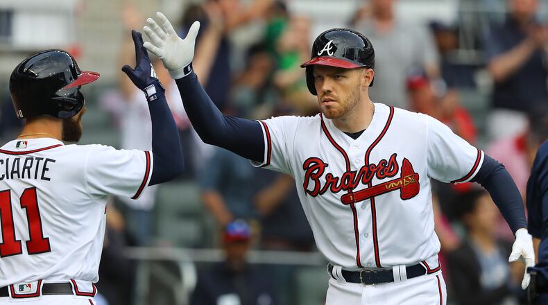 March 29, 2018 Atlanta: Atlanta Braves first baseman Freddie Freeman gets five from Ender Inciarte hitting a 2-run homer against the Phillies during the sixth inning in a MLB baseball home opening game on Thursday, March 29, 2018, in Atlanta.  Curtis Compton/ccompton@ajc.com
