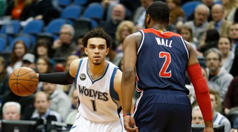 Minnesota Timberwolves guard Tyus Jones (1) controls the ball against Washington Wizards guard John Wall (2) in the first half of an NBA basketball game Wednesday, March 2, 2016 in Minneapolis. (AP Photo/Stacy Bengs)