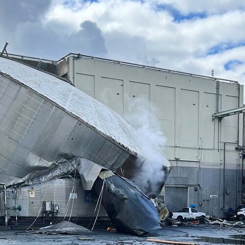 This photo provided by the City of Longview, Wash., shows structural damage to the Nippon Dynawave Packaging Co., after a tank containing hazardous liquid imploded, on Tuesday, May 26, 2026 in Longview, Wash. (City of Longview via AP)