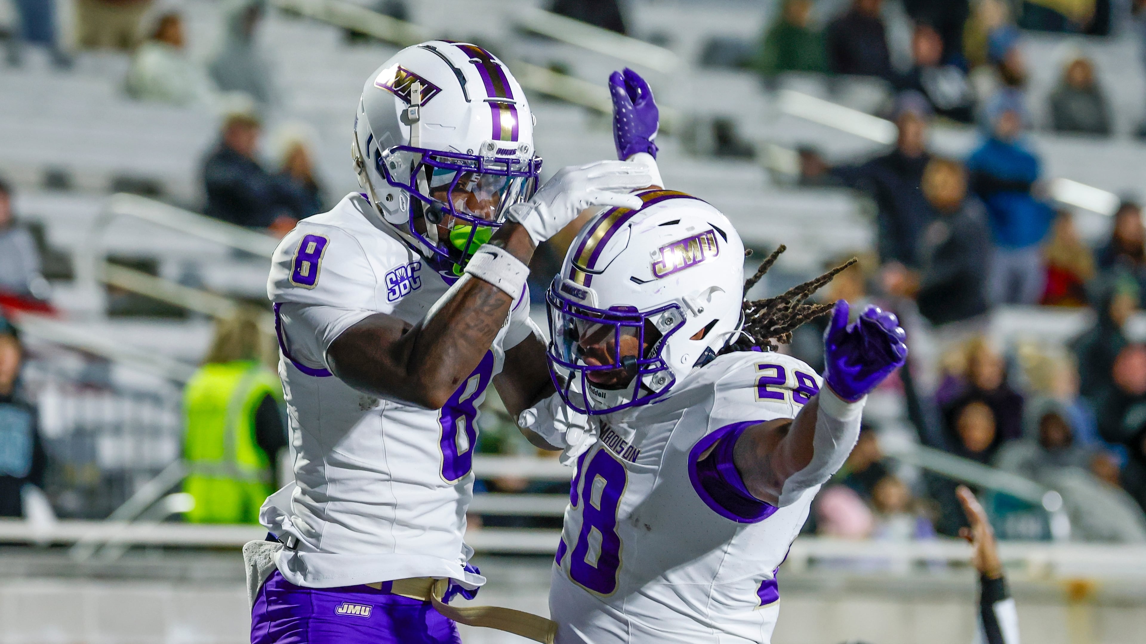 James Madison wide receiver Isaiah Alston (8) celebrates with running back Jobi Malary, right, after catching a touchdown pass against Coastal Carolina during the second half of an NCAA college football game in Conway, S.C., Saturday, Nov. 29, 2025. (AP Photo/Nell Redmond)