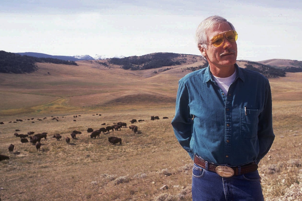 Ted Turner stands near a herd of his bison in this September 1991 file photo at his 107,000-acre Flying D Ranch near Bozeman, Mont. After buying a few American buffalo two decades ago mainly just to look at on his Florida farm, Turner has developed his herd into the nation's largest with some 15,000 on ranches in Montana, Nebraska and New Mexico. (Linda Best/AP/Bozeman Daily Chronicle/File)