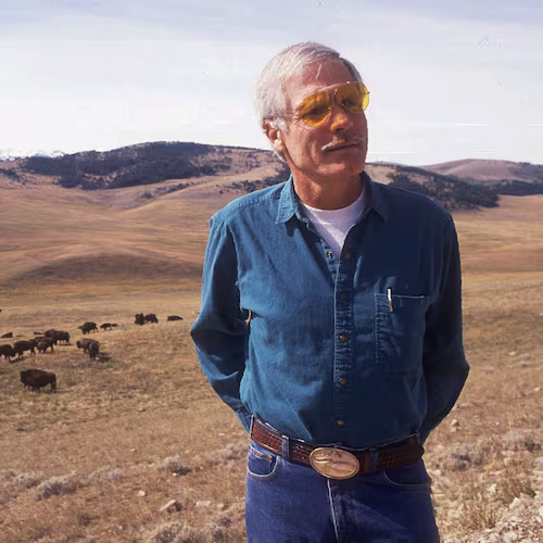 Ted Turner stands near a herd of his bison in this September 1991 file photo at his 107,000-acre Flying D Ranch near Bozeman, Mont. After buying a few American buffalo two decades ago mainly just to look at on his Florida farm, Turner has developed his herd into the nation's largest with some 15,000 on ranches in Montana, Nebraska and New Mexico. (Linda Best/AP/Bozeman Daily Chronicle/File)