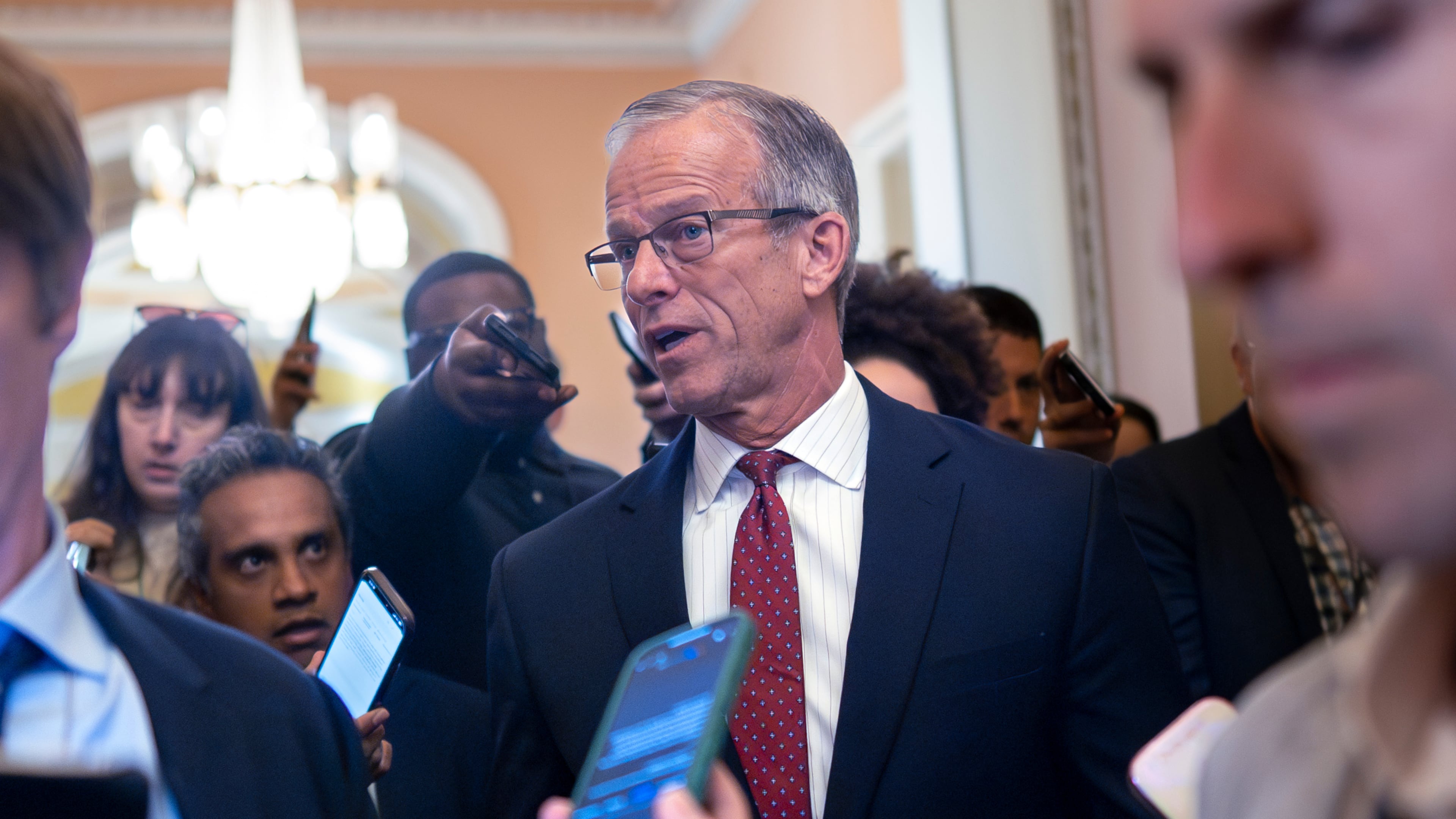 Senate Majority Leader John Thune, R-S.D., pauses in his office doorway to speak to reporters on day 20 of the government shutdown, at the Capitol in Washington, Monday, Oct. 20, 2025. (AP Photo/J. Scott Applewhite)