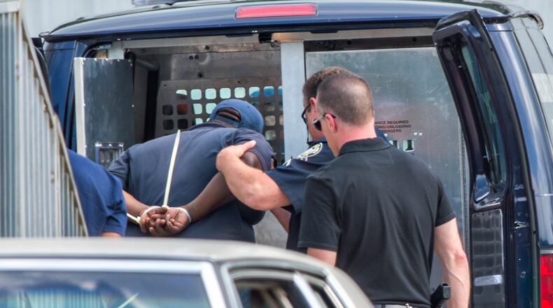 Kenneth Carson, Antonio Denson and Larry Tyler are loaded into an Atlanta Police prisoner transport van as they are arrested at the Atlanta Department of Watershed Management Pipe Yard off of Peyton Road in Atlanta on Monday, May 18, 2015. Carson, Denson, Tyler and a fourth employee, Aaron Avery, are charged with theft by taking as part of an ongoing internal and external investigation. The four are accused of exchanging water meters, copper and brass at recycling centers.
