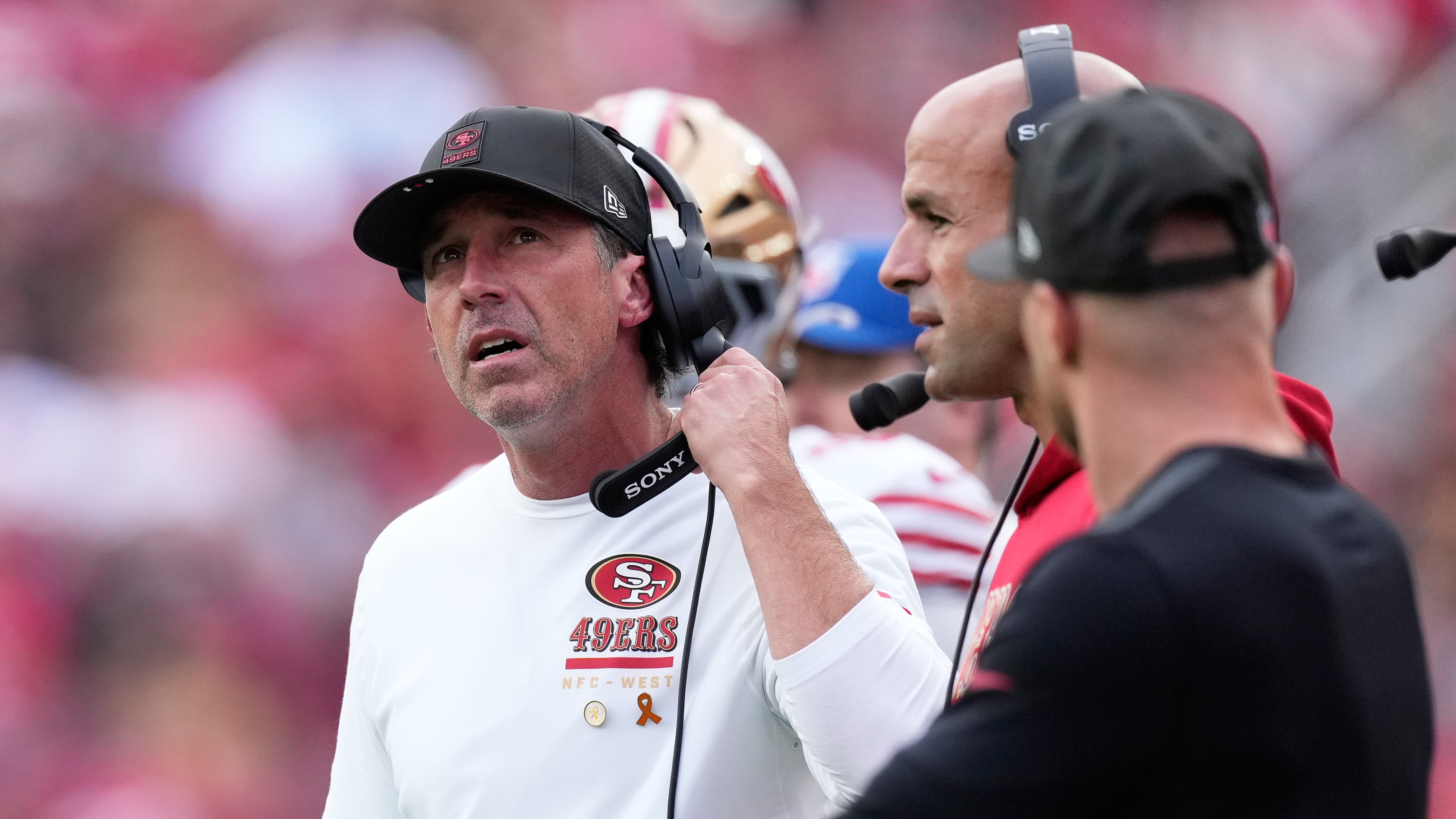 San Francisco 49ers head coach Kyle Shanahan, left, reacts next to defensive coordinator Robert Saleh, middle, during the first half of an NFL football game against the Jacksonville Jaguars in Santa Clara, Calif., Sunday, Sept. 28, 2025. (AP Photo/Godofredo A. Vásquez)