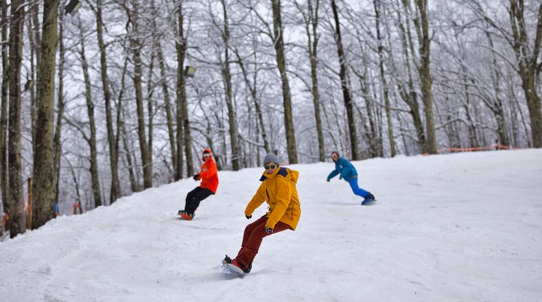Snowboarders tackle a run at Cataloochee Ski Area in Maggie Valley, North Carolina.