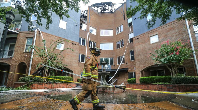 Atlanta firefighters remained on the fire scene Thursday, Aug. 20, 2020, where the number of people displaced by Wednesday’s massive apartment fire in Buckhead grew, the American Red Cross said Thursday. It took more than 18 hours to bring Wednesday's massive fire at the Avana on Main under control. Atlanta firefighters remain on the scene Thursday morning. (John Spink / JSpink@ajc.com)