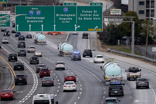 A convoy of Georgia Department of Transportation brine trucks treated roads in downtown Atlanta on Friday. (Ben Hendren for the AJC)