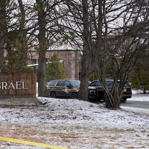 Police vehicles sit outside the Temple Israel synagogue Friday, March 13, 2026, in West Bloomfield Township, Mich. (AP Photo/Paul Sancya)