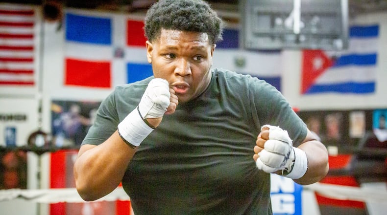 Atlanta boxer DaCarree "Mactruck" Scott (R) works out with the owner of Champs Boxing and Fitness Pete Crumpley in Smyrna Friday 12, 2021. STEVE SCHAEFER FOR THE ATLANTA JOURNAL-CONSTITUTION