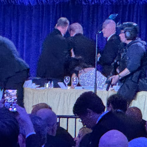 U.S. Secret Service agents surround President Donald Trump, third from left, as he is taken from the stage after a shooting incident outside the ballroom during the White House Correspondents Dinner, Saturday, April 25, 2026, in Washington. (AP Photo/Mark Schiefelbein)