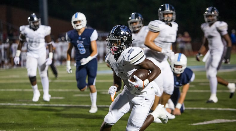 Christian Isibor, running back for Cambridge, rushes the ball during the Cambridge v. Alpharetta high school football game on Friday, September 2, 2022, at Cambridge High School in Milton, Georgia. Alpharetta defeated Cambridge 43-38. CHRISTINA MATACOTTA FOR THE ATLANTA JOURNAL-CONSTITUTION.