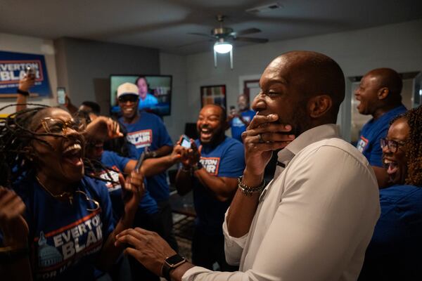 Friends, campaign staff and supporters scream with surprise and delight as former Gwinnett County School Board Chair Everton Blair Jr. (right) celebrates winning the special election runoff for Georgia's 13th Congressional District on Tuesday. (Olivia Bowdoin for the AJC)
