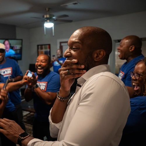 Friends, campaign staff and supporters scream with surprise and delight as former Gwinnett County School Board Chairman Everton Blair Jr. (right) celebrates winning the special election runoff for Georgia’s 13th Congressional District, defeating fellow Democrat Marcye Scott to succeed the late U.S. Rep. David Scott, in Lilburn, Ga., Tuesday, Aug. 25, 2026. (Olivia Bowdoin for the AJC)
