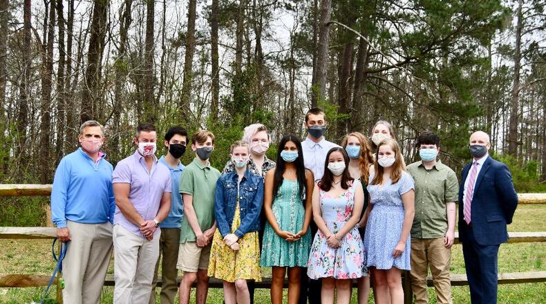 The Walton High mock trial team has placed third in statewide competition. (L-R) are Bill Atkins (with Charlie the dog), Judge Chris Sprague, Andrew Lee, Collin Marbutt, Grace Hardy, Piran Terlesky, Sanya Kaushal, Omer Inan, Mika Dennerline, Jenny Krakowski, Elise Johnson, Sarah Hardy, Gryffin Crowder-White and Judge Jason Marbutt. (Courtesy of Cobb County)