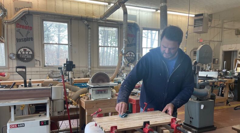 Randy Bampfield creating a cutting board at the Roswell FireLabs. (Photo by Karen Huppertz for the AJC)