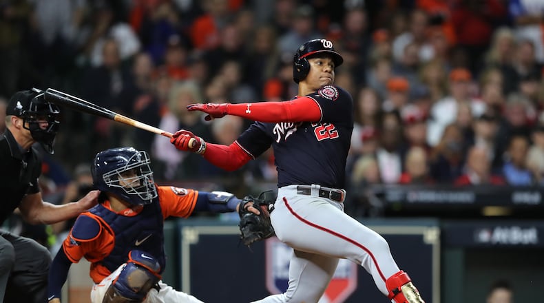 Juan Soto of the Washington Nationals hits an RBI single against the Houston Astros during the eighth inning in Game Seven of the 2019 World Series at Minute Maid Park on October 30, 2019 in Houston, Texas. (Photo by Elsa/Getty Images)