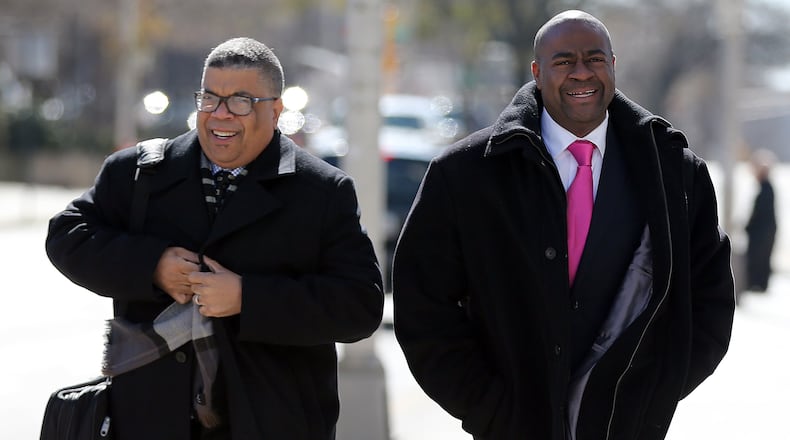 Jerry Clark, right, former DeKalb Zoning Board of Appeals member, and his attorney Gary Spencer walked to federal court on Feb. 19, 2015 before Clark pleaded guilty. BEN GRAY / BGRAY@AJC.COM