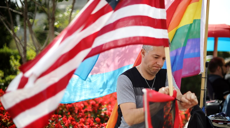 Eddie Reynoso of San Diego, California, attaches an American flag his chair on Oct. 7, 2019, while waiting in line outside the U.S. Supreme Court building for the chance to attend arguments in Bostock v. Clayton County. (Chip Somodevilla/Getty Images)