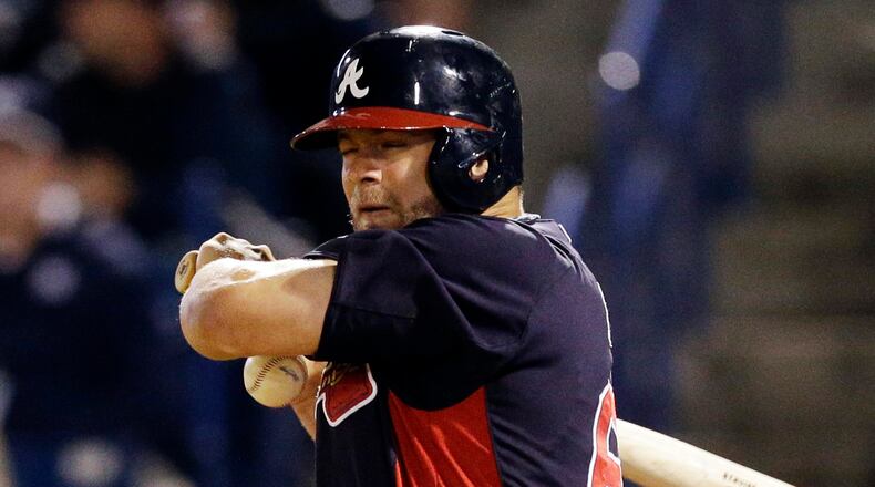Braves' Evan Gattis is hit by a pitch from New York Yankees' Mark Montgomery during the sixth inning.