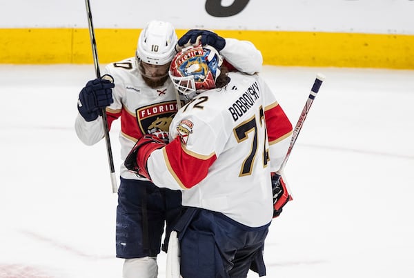 Florida Panthers' A.J. Greer (10) and Sergei Bobrovsky (72) celebrate after their win over the Edmonton Oilers in Game 5 of the NHL hockey Stanley Cup Final in Edmonton, Alberta, Saturday, June 14, 2025. ( Jason Franson/The Canadian Press via AP)
