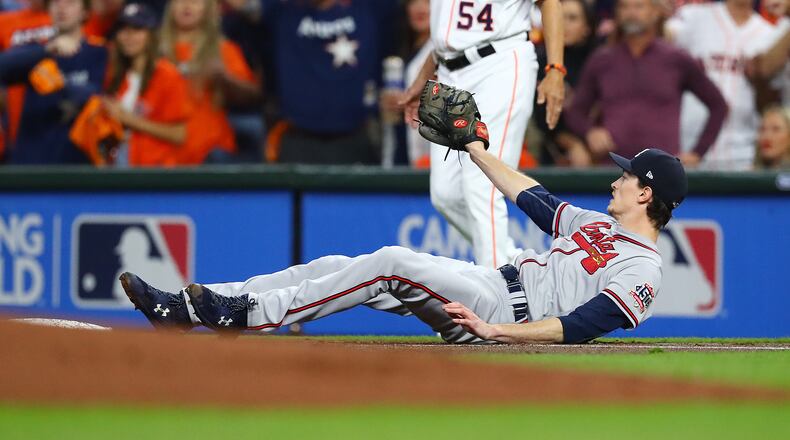 110221 HOUSTON: Braves starting and winning pitcher Max Fried falls after colliding with Astros Michael Brantley while fielding at first base in game 6 of the World Series on Tuesday, Nov. 2, 2021, in Houston.   “Curtis Compton / Curtis.Compton@ajc.com”