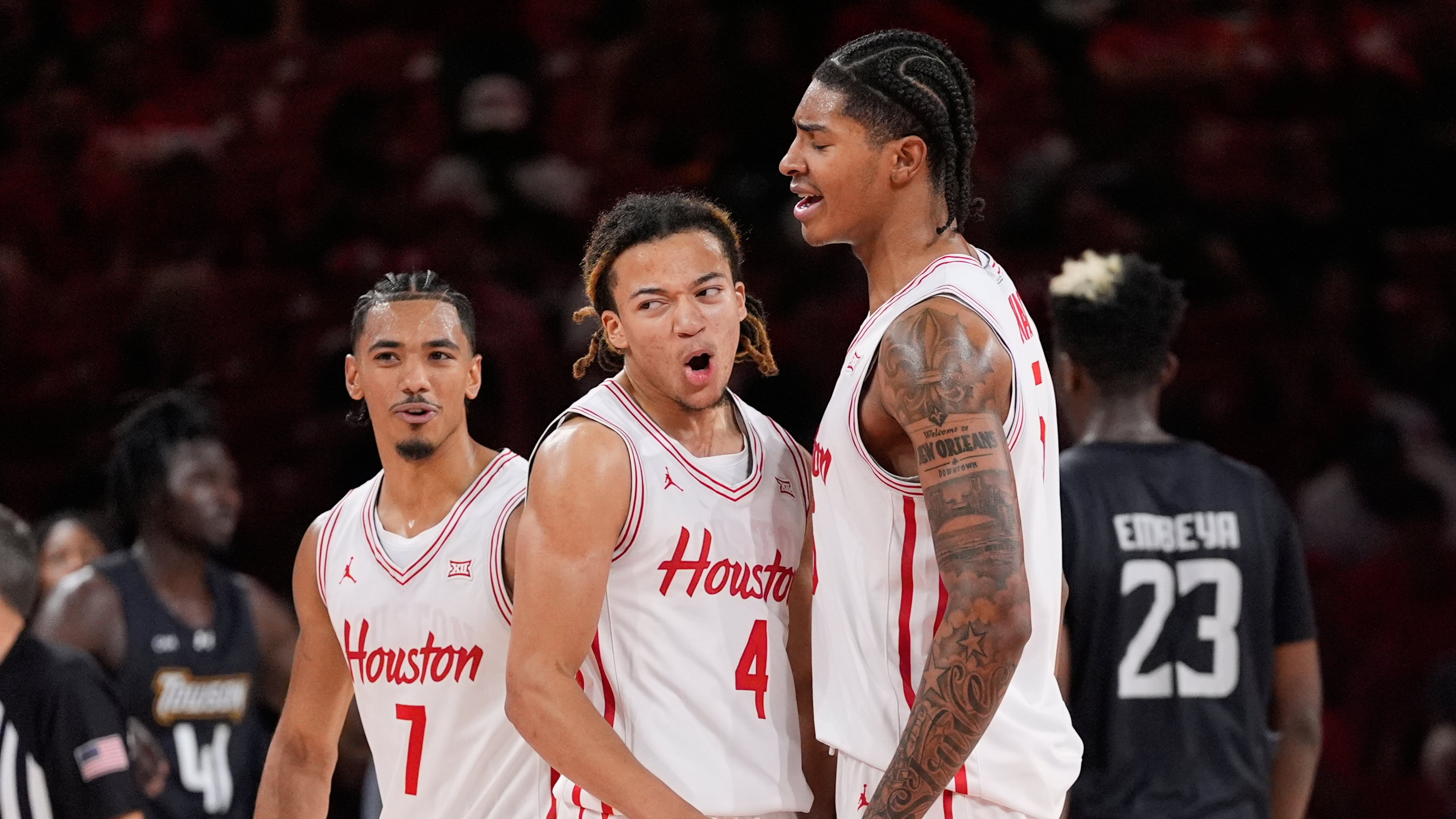 Houston guard Milos Uzan (7), guard Kingston Flemings (4) and center Chris Cenac Jr. (5) celebrate during the second half of an NCAA college basketball game against the Towson Tigers in Houston, Saturday, Nov. 8, 2025. (AP Photo/Ashley Landis)