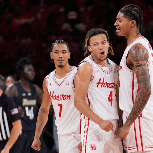 Houston guard Milos Uzan (7), guard Kingston Flemings (4) and center Chris Cenac Jr. (5) celebrate during the second half of an NCAA college basketball game against the Towson Tigers in Houston, Saturday, Nov. 8, 2025. (AP Photo/Ashley Landis)