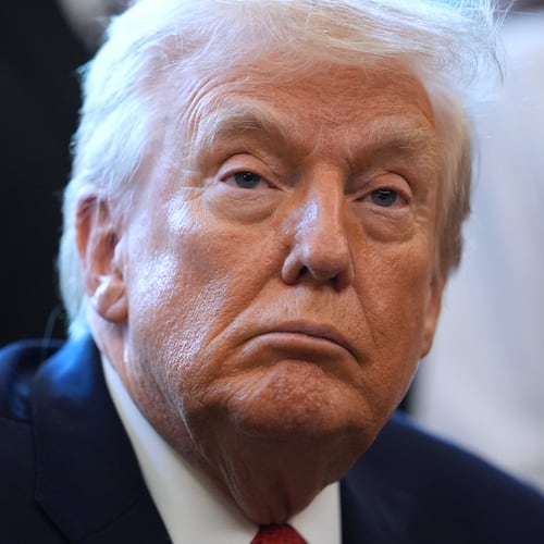 President Donald Trump listens before he signs an executive order reclassifying marijuana as a less dangerous drug in the Oval Office of the White House, Thursday, Dec. 18, 2025, in Washington. (AP Photo/Evan Vucci)