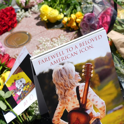 Dolly Parton's star on the Hollywood Walk of Fame is decorated with flowers Tuesday, Aug. 25, 2026, in Los Angeles. (AP Photo/Chris Pizzello)