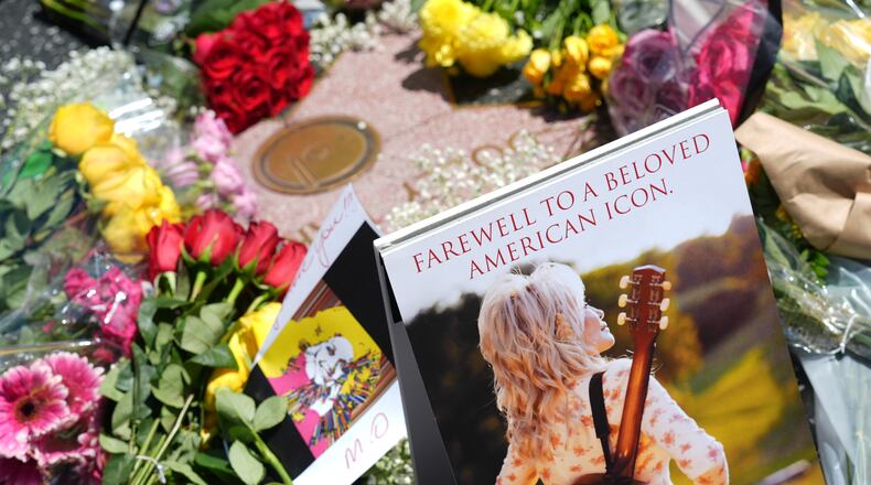 Dolly Parton's star on the Hollywood Walk of Fame is decorated with flowers Tuesday, Aug. 25, 2026, in Los Angeles. (AP Photo/Chris Pizzello)