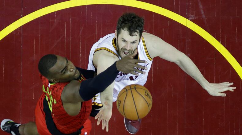 Cleveland Cavaliers' Kevin Love (0) shoots against Atlanta Hawks' Paul Millsap (4) in the second half in Game 1 of a second-round NBA basketball playoff series, Monday, May 2, 2016, in Cleveland. The Cavaliers won 104-93. (AP Photo/Tony Dejak)