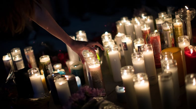 Mourners light candles in memory of the Las Vegas shooting victims. Photo by Drew Angerer/Getty Images