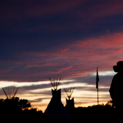 A man walks back to camp during festivities commemorating the 150th anniversary of the Battle of the Little Bighorn, Wednesday, June 24, 2026, in Crow Agency, Mont. (AP Photo/Tailyr Irvine)